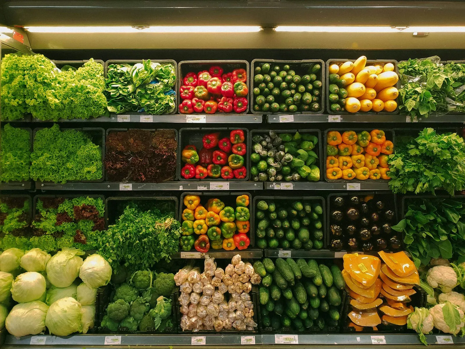 Shelves of fruit and vegetables stacked on a greengrocer's display