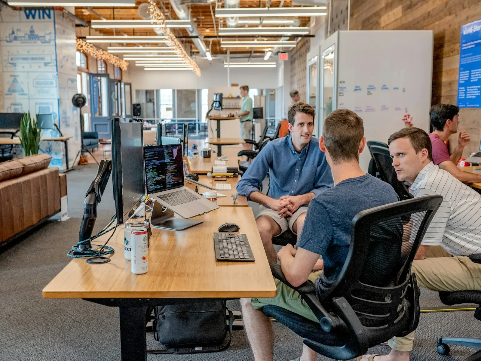 A small team working at desks in a shared studio space